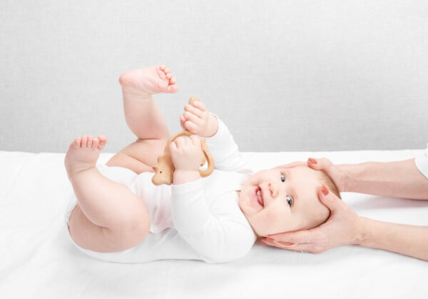 Little baby receiving osteopathic treatment of head and neck